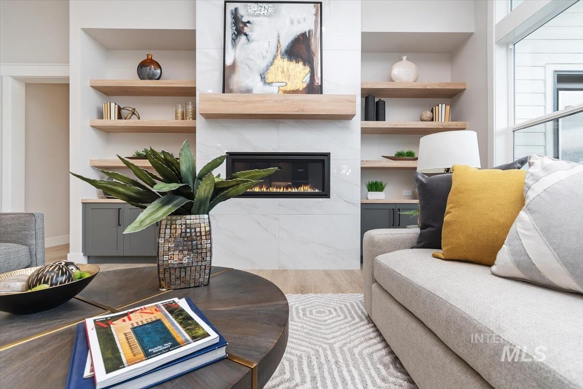 357 West Flour Mill Middleton, ID 83644 - Photo 9 of 49 Living room featuring built in shelves, a tiled fireplace, and wood finished floors