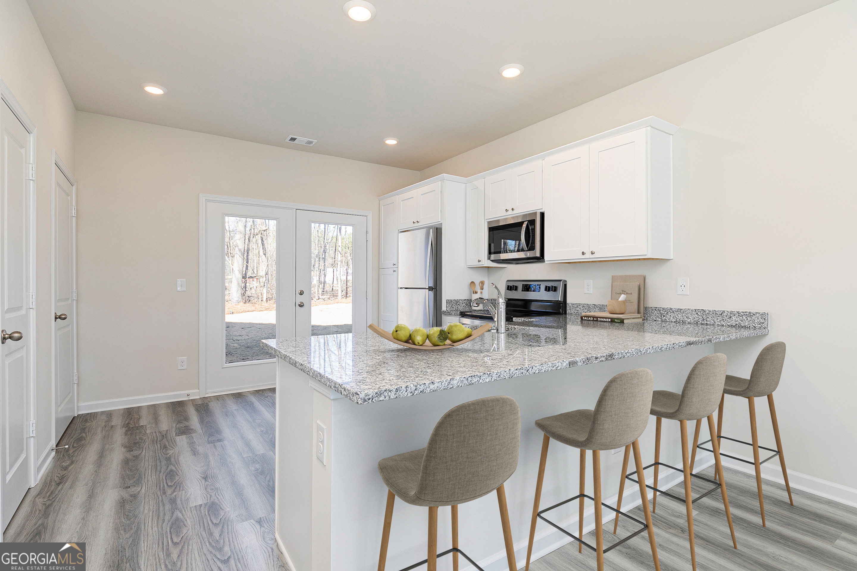 214 Rooker Drive LaGrange, GA 30241 - Photo 5 of 15 a kitchen with granite countertop counter space dining table and stainless steel appliances