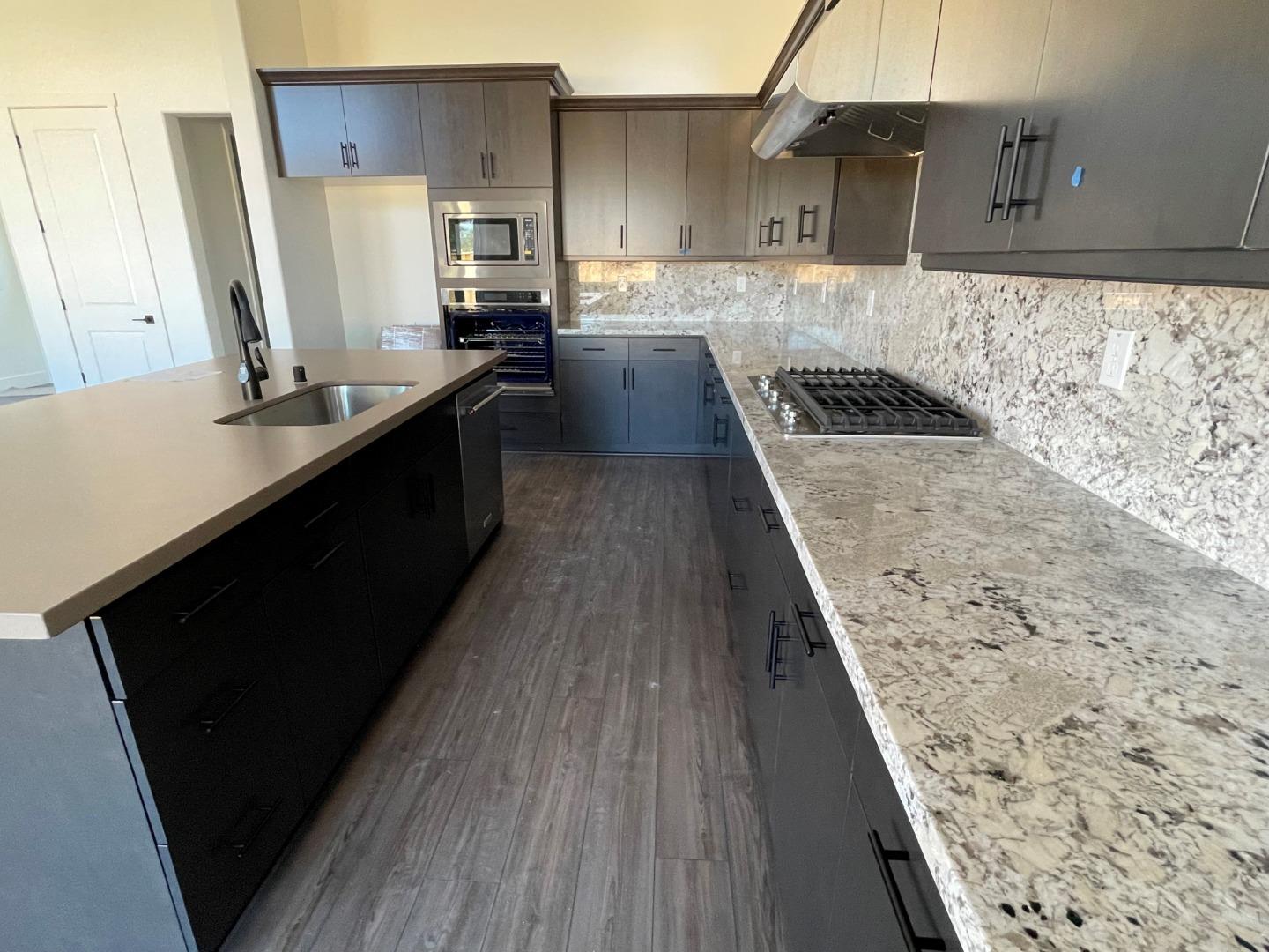 483 Russell Way Marina, CA 93933 - Photo 3 of 7 a kitchen with wooden floors and a sink