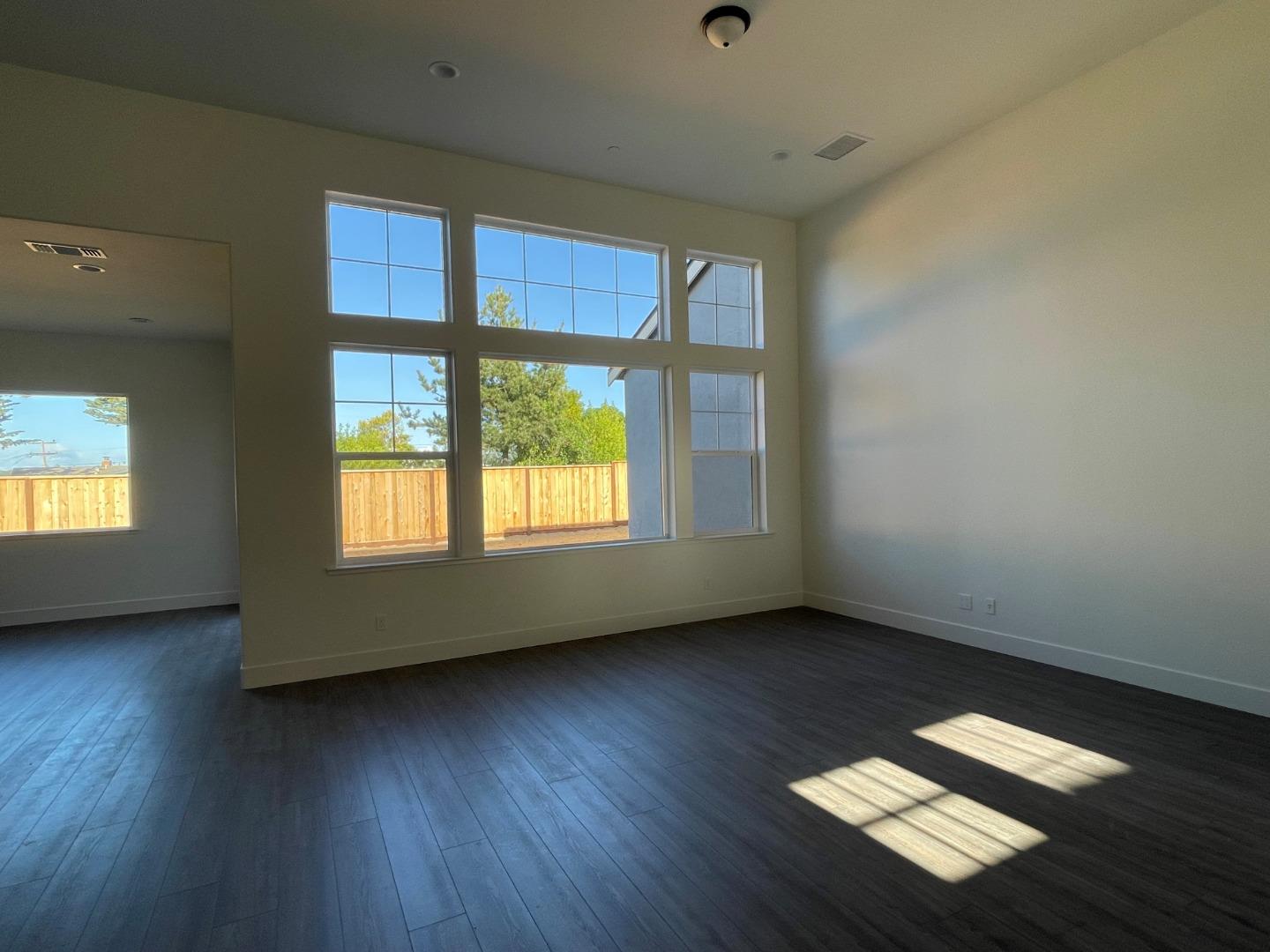 483 Russell Way Marina, CA 93933 - Photo 4 of 7 an empty room with wooden floor and windows
