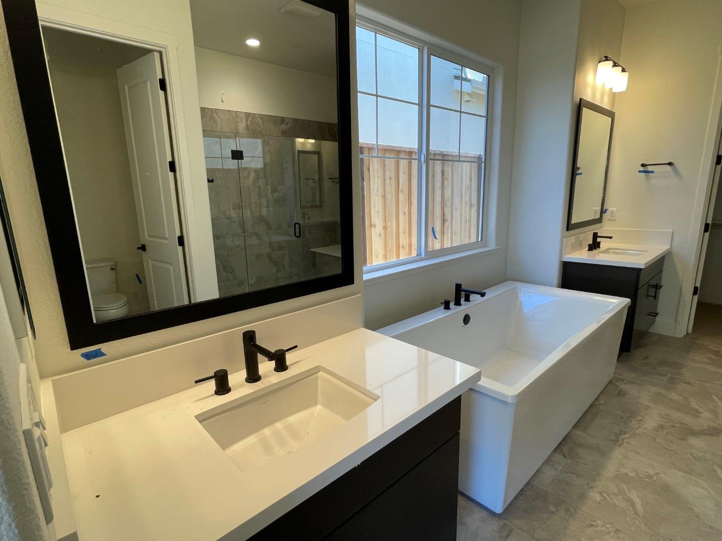 483 Russell Way Marina, CA 93933 - Photo 6 of 7 a bathroom with a sink vanity tub and a mirror