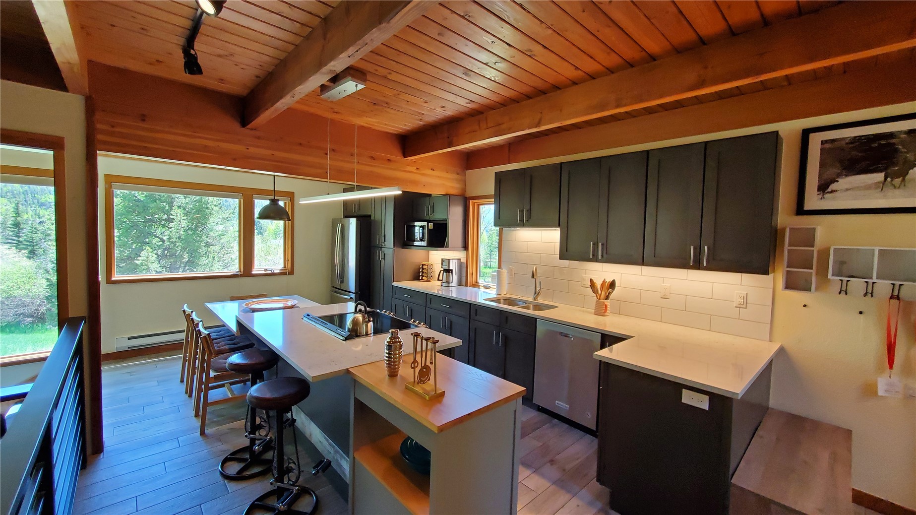 620 Tennis Club Road, Unit 1337 Keystone, CO 80435 - Photo 5 of 48 a kitchen with a sink a stove a dining table and chairs with wooden floor