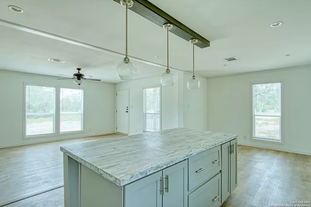 an empty room with a window and wooden floor