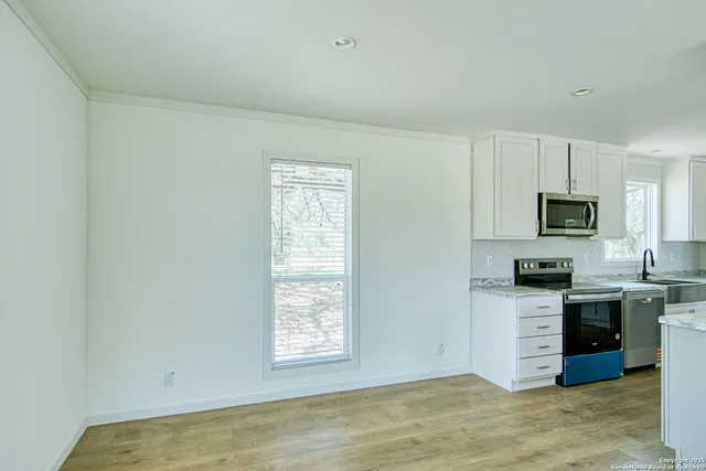 a view of a kitchen with microwave and cabinets