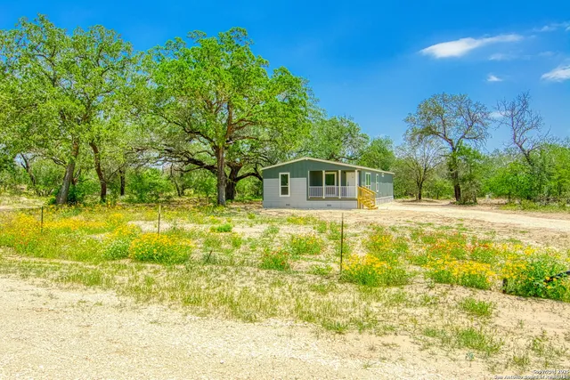 a swimming pool with trees in the background
