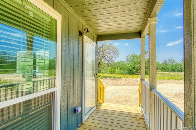a view of a glass door with the balcony