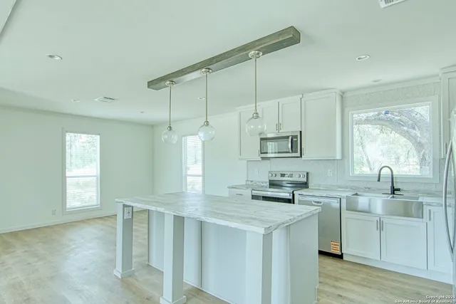 a kitchen with a sink cabinets and window