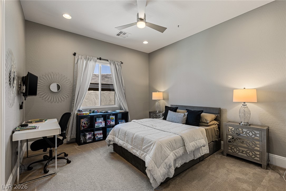 10118 Copper Edge Road Las Vegas, NV 89148 - Photo 25 of 48 Recessed lighting and a ceiling fan illuminate this comfortable bedroom space.