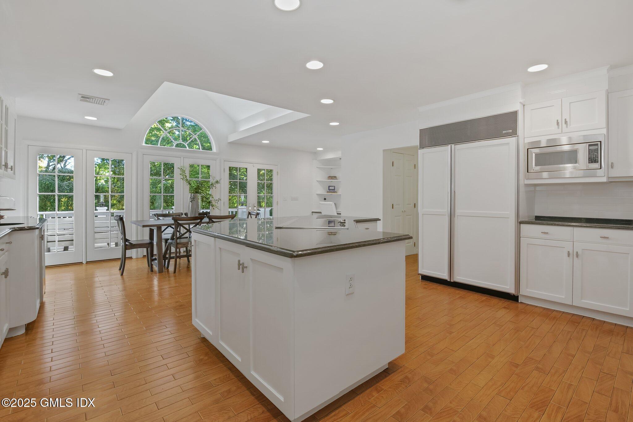 8 Tinker Lane Greenwich, CT 06830 - Photo 12 of 41 a kitchen with stainless steel appliances granite countertop a stove top oven a sink and a refrigerator