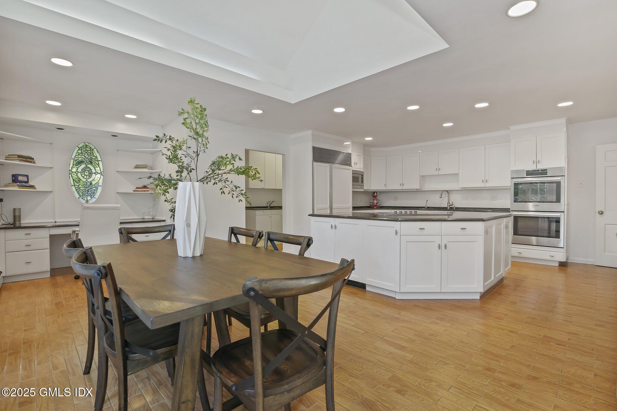 8 Tinker Lane Greenwich, CT 06830 - Photo 13 of 41 a kitchen with a table and chairs in it