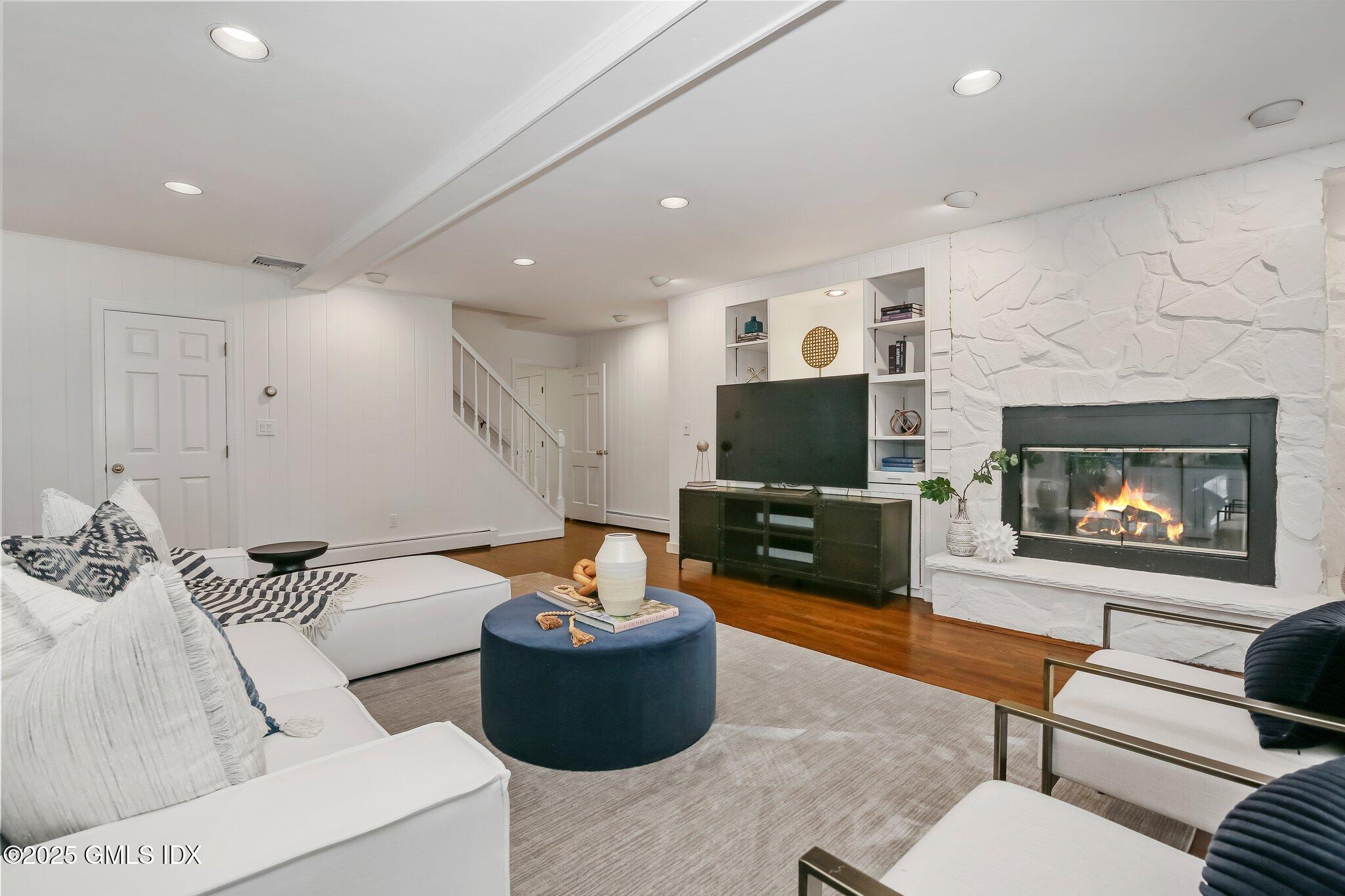 8 Tinker Lane Greenwich, CT 06830 - Photo 15 of 41 a living room with furniture and a flat screen tv