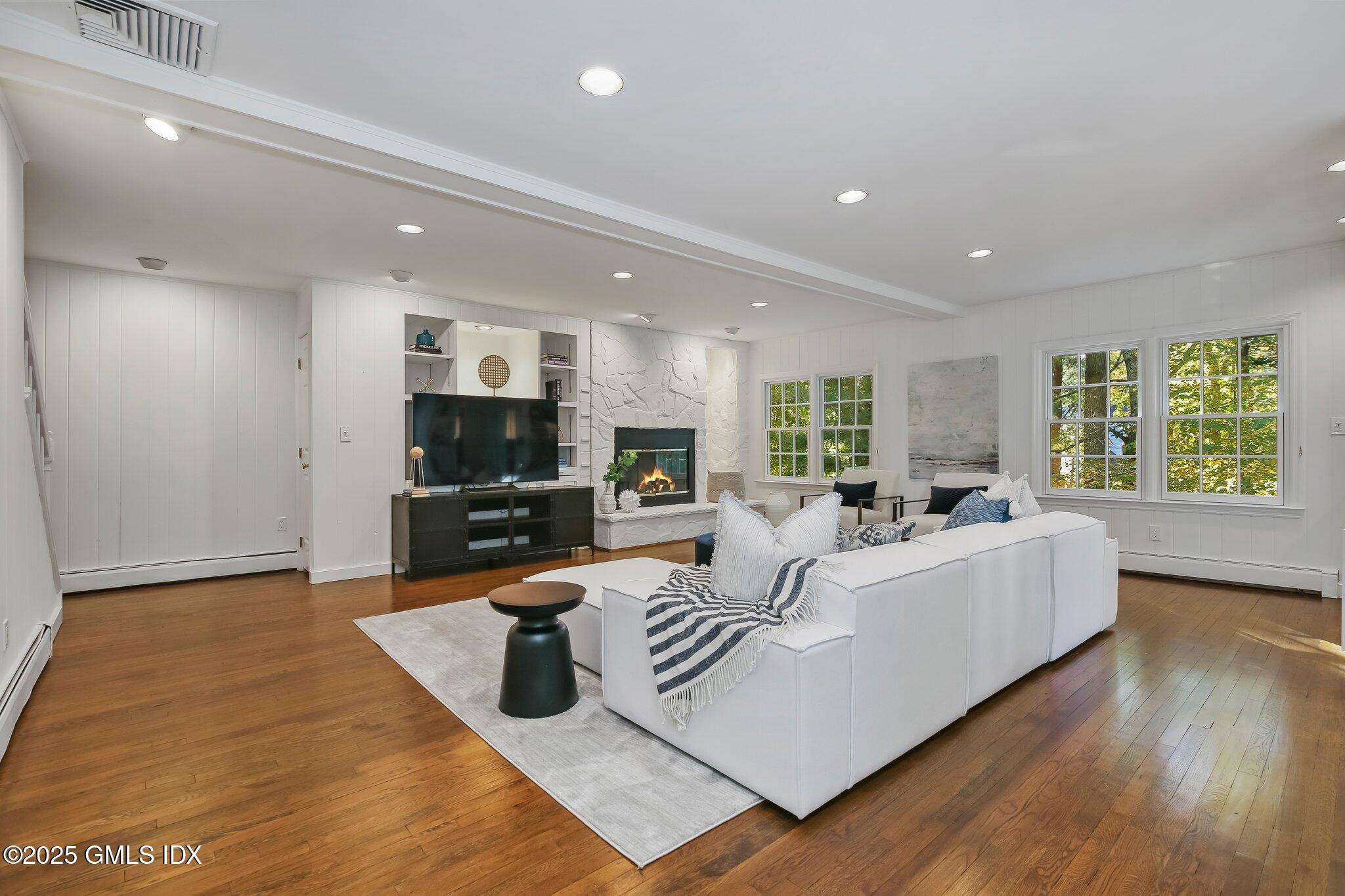 8 Tinker Lane Greenwich, CT 06830 - Photo 16 of 41 a living room with furniture wooden floor and a kitchen view