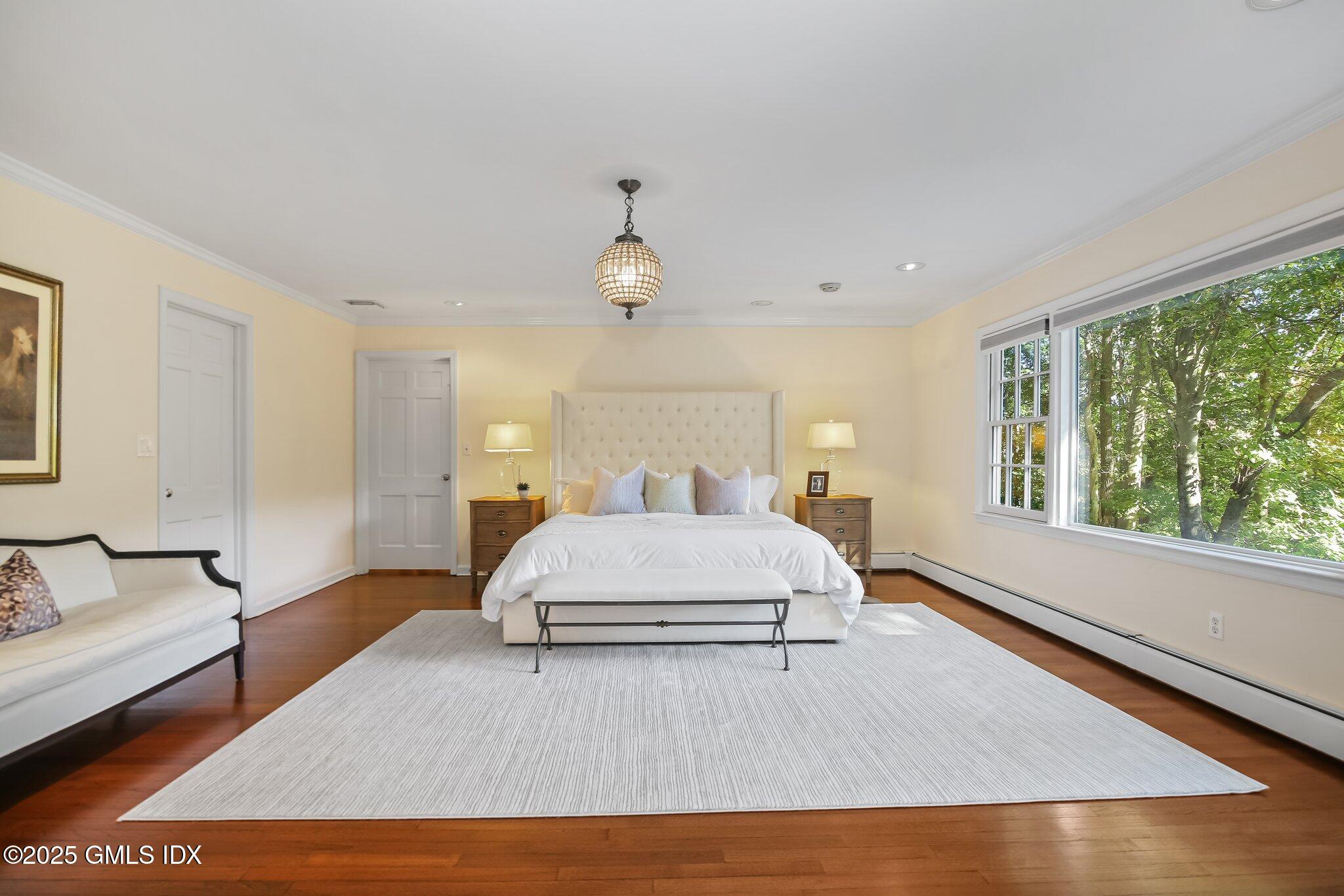 8 Tinker Lane Greenwich, CT 06830 - Photo 19 of 41 a bedroom with a large bed and wooden floor