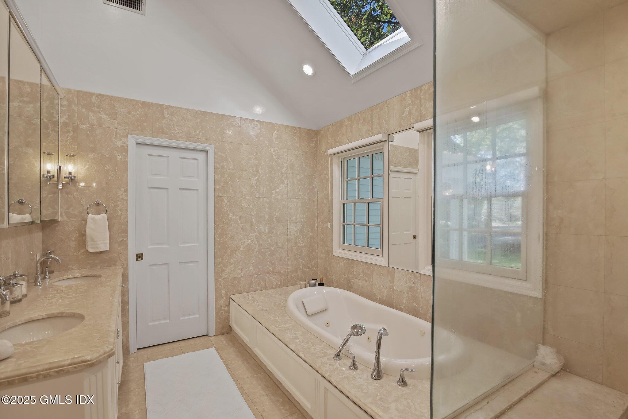 8 Tinker Lane Greenwich, CT 06830 - Photo 21 of 41 a bathroom with a tub shower and sink