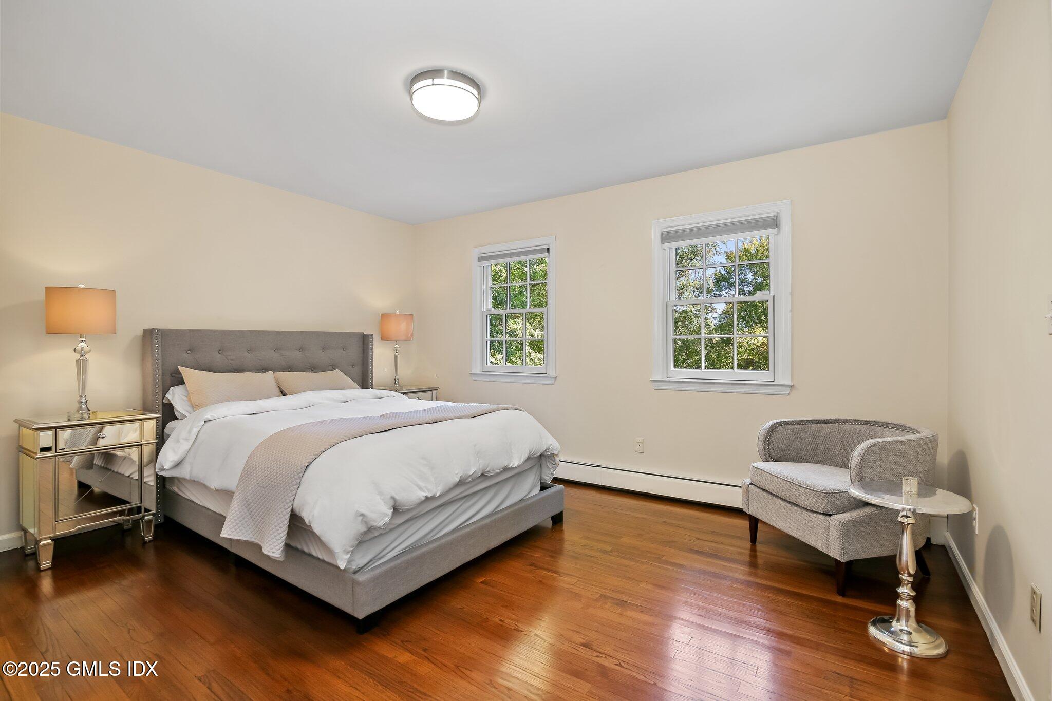 8 Tinker Lane Greenwich, CT 06830 - Photo 22 of 41 a bedroom with a bed chair and a window