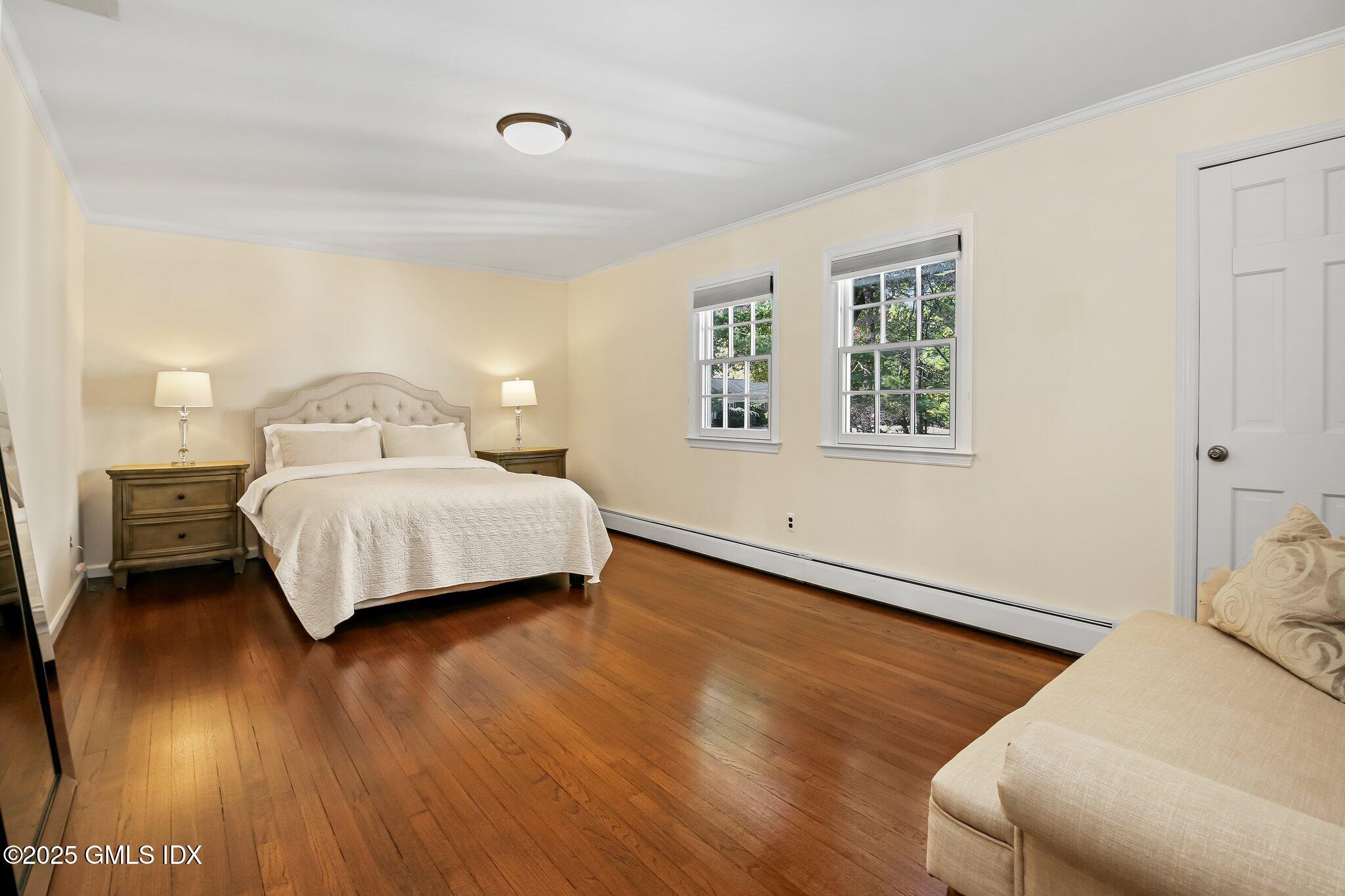 8 Tinker Lane Greenwich, CT 06830 - Photo 23 of 41 a bedroom with a bed and wooden floor