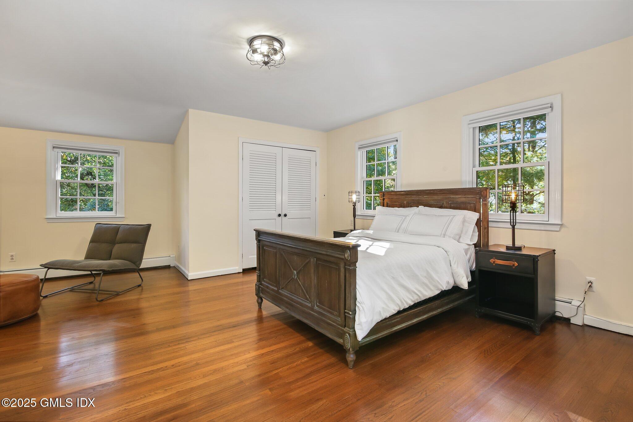 8 Tinker Lane Greenwich, CT 06830 - Photo 25 of 41 a bedroom with a bed and wooden floor