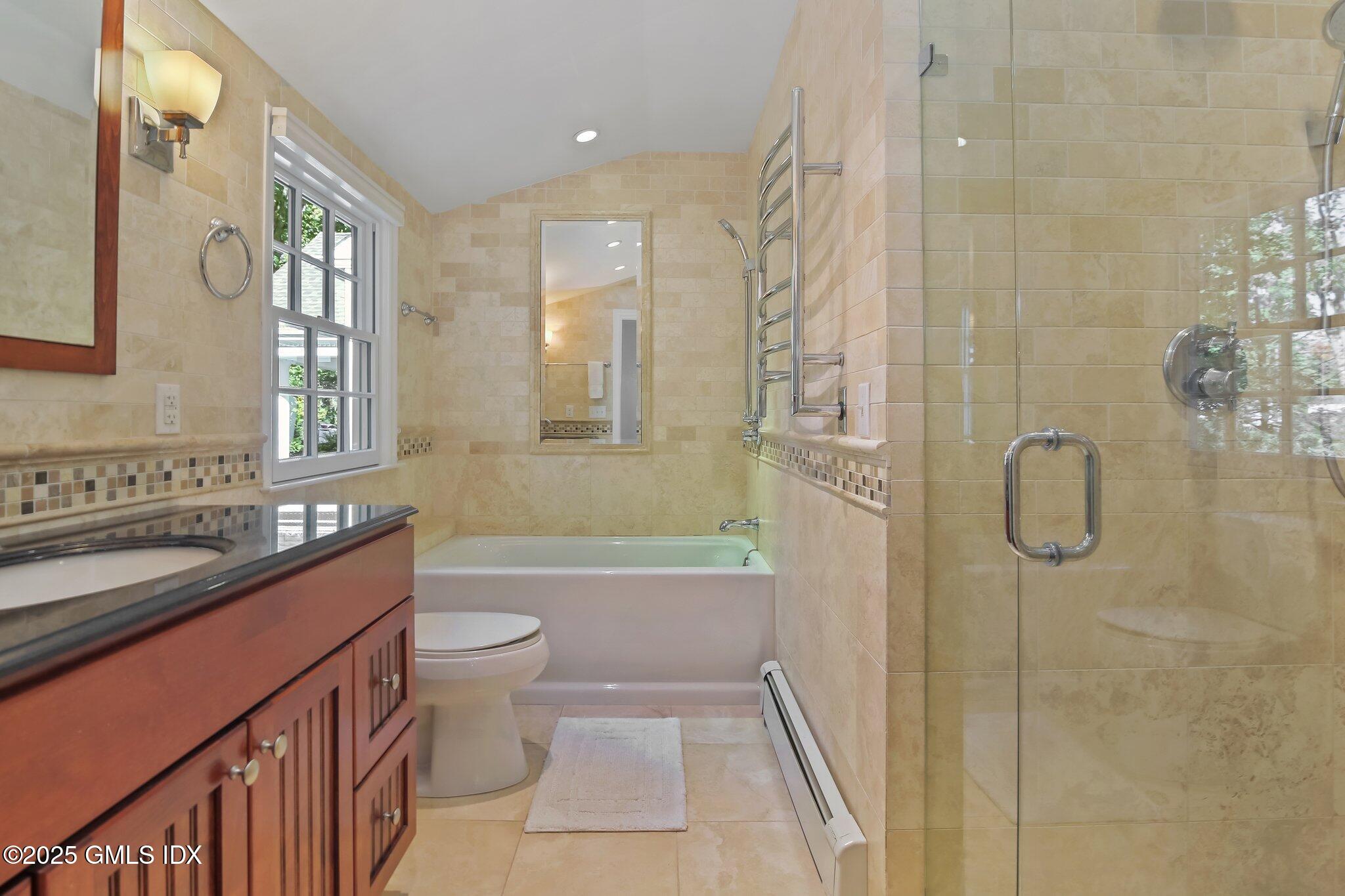 8 Tinker Lane Greenwich, CT 06830 - Photo 26 of 41 a bathroom with a granite countertop sink a toilet a mirror a vanity and shower