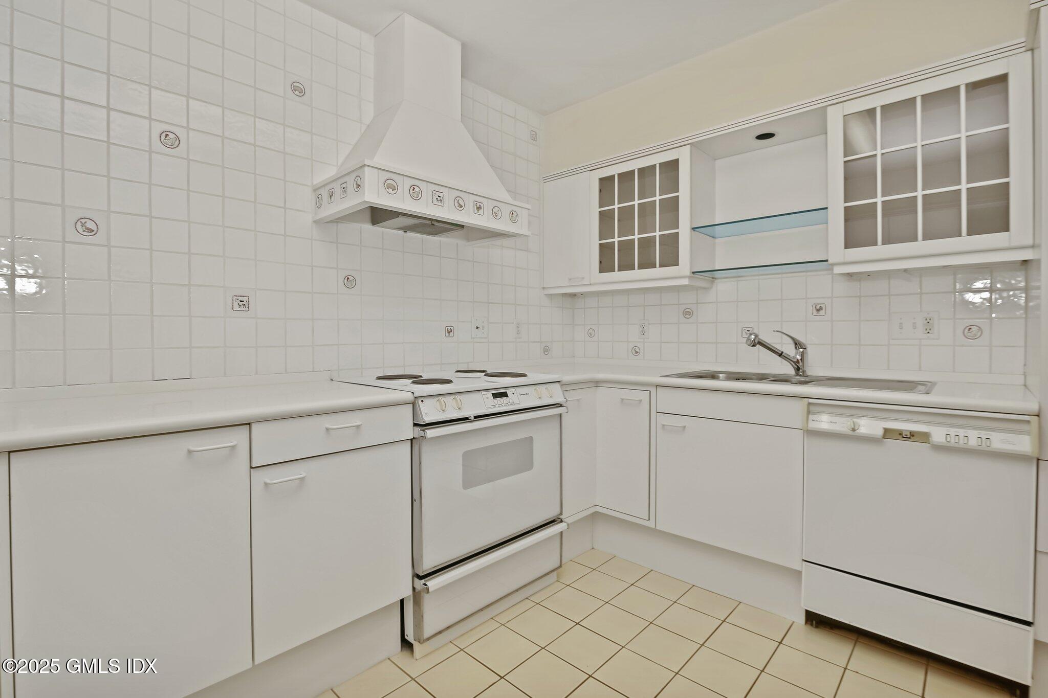 8 Tinker Lane Greenwich, CT 06830 - Photo 28 of 41 a kitchen with granite countertop white cabinets and white appliances