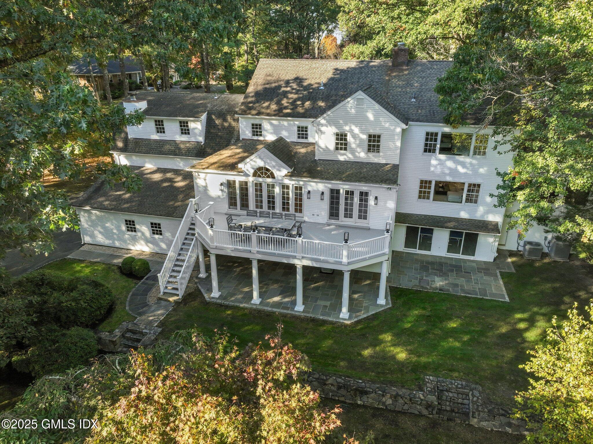 8 Tinker Lane Greenwich, CT 06830 - Photo 3 of 41 a front view of a house with a garden