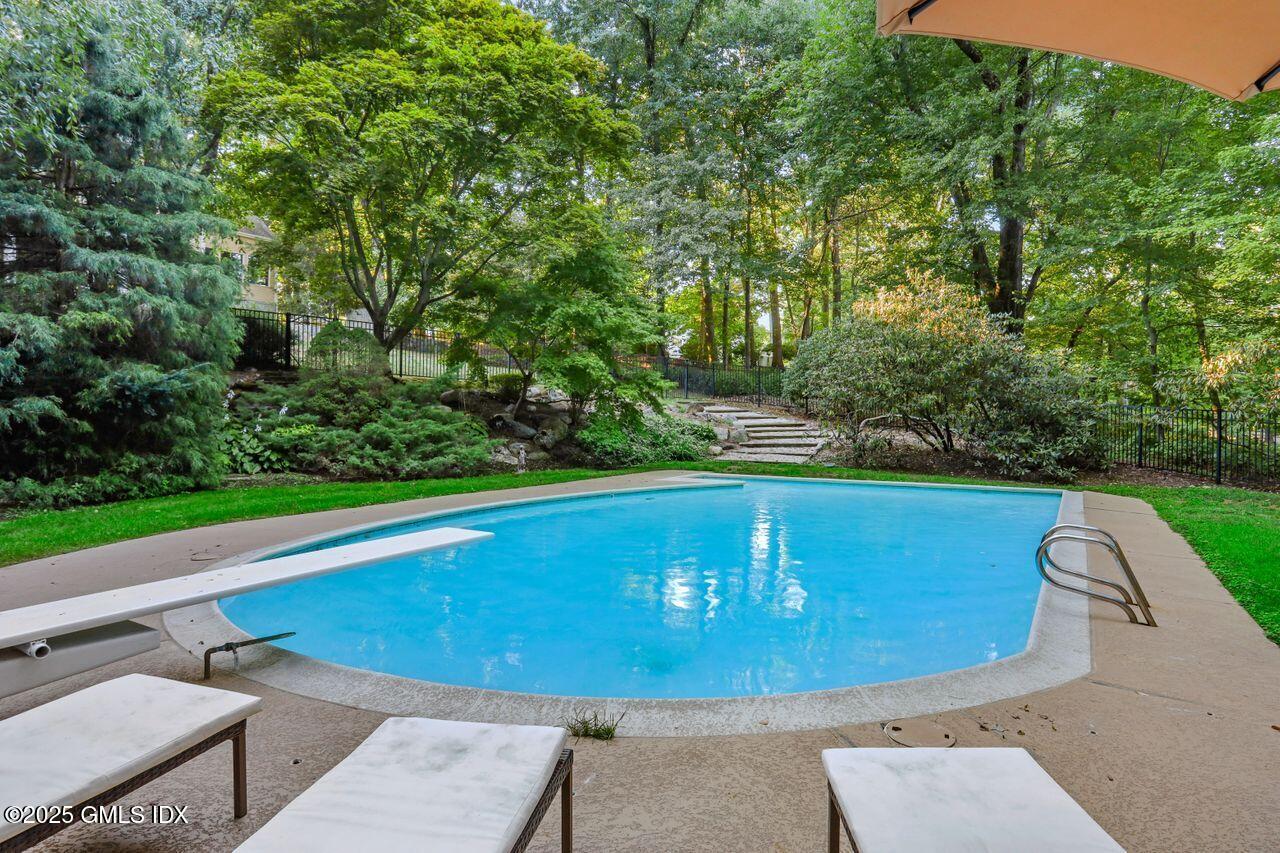 8 Tinker Lane Greenwich, CT 06830 - Photo 34 of 41 a view of a swimming pool with a patio and a yard