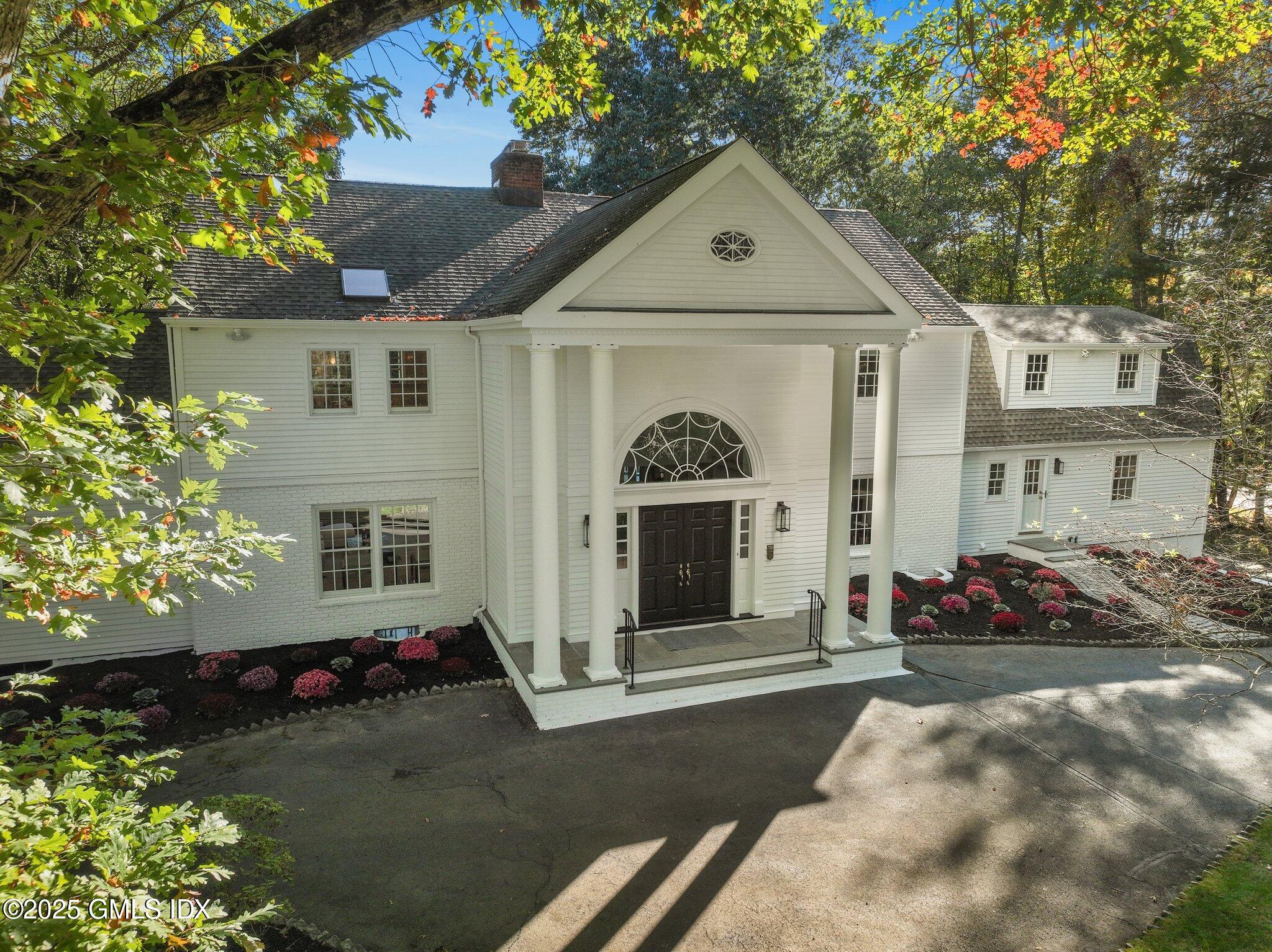 8 Tinker Lane Greenwich, CT 06830 - Photo 40 of 41 a front view of a house with a yard