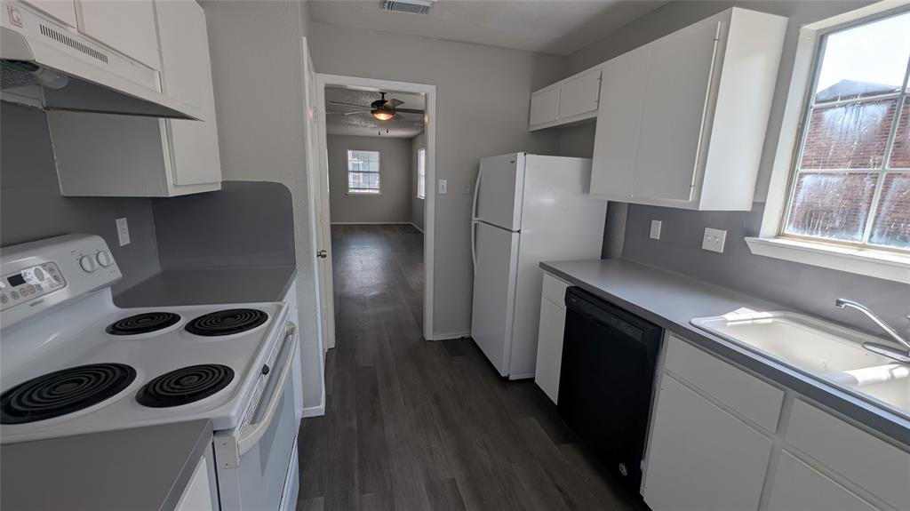 107 Beck Street, Unit B Florence, TX 76527 - Photo 3 of 8 A well-appointed kitchen featuring a window overlooking the surroundings, offering both functionality and comfort.