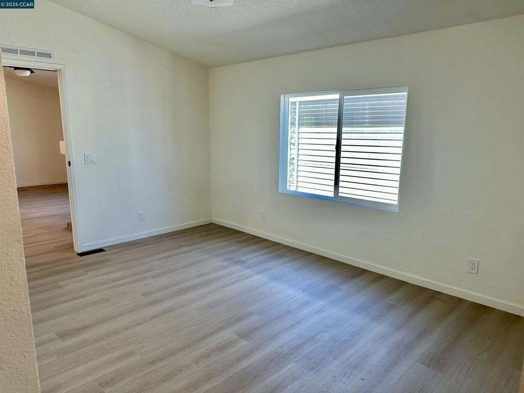 60 Wilson Way Milpitas, CA 95035 - Photo 16 of 22 an empty room with wooden floor and windows