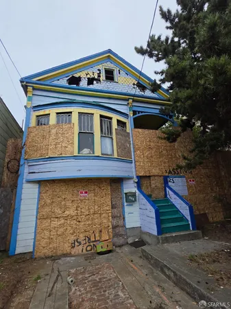 a front view of house with a garden