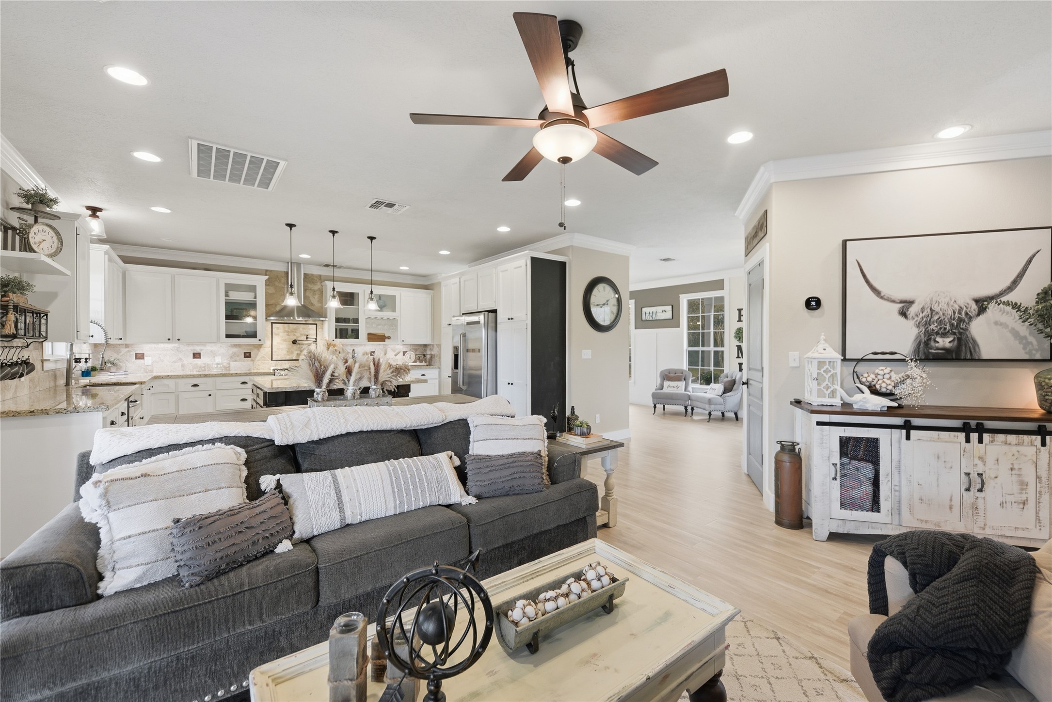 305 Affleck Road Brenham, TX 77833 - Photo 14 of 43 a living room with furniture kitchen view and a chandelier