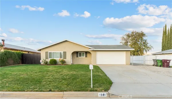 a view of house that has a yard
