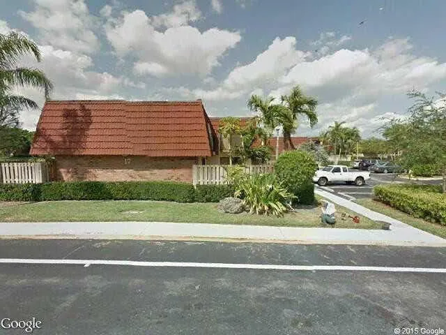 a view of a brick building next to a yard