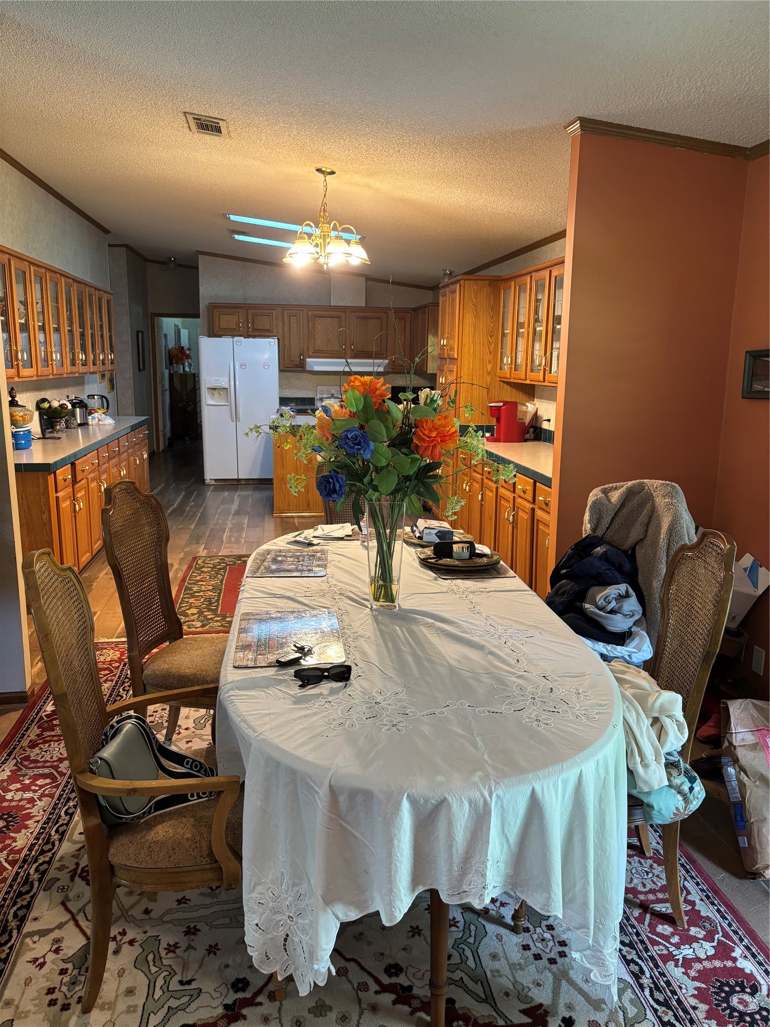 35599 State Highway South Buna, TX 77612 - Photo 21 of 40 a kitchen with stainless steel appliances kitchen island granite countertop a table chairs and a refrigerator