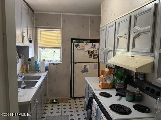 5214 Carter Spencer Road Middleburg, FL 32068 - Photo 20 of 50 a kitchen with stainless steel appliances granite countertop a sink stove and refrigerator