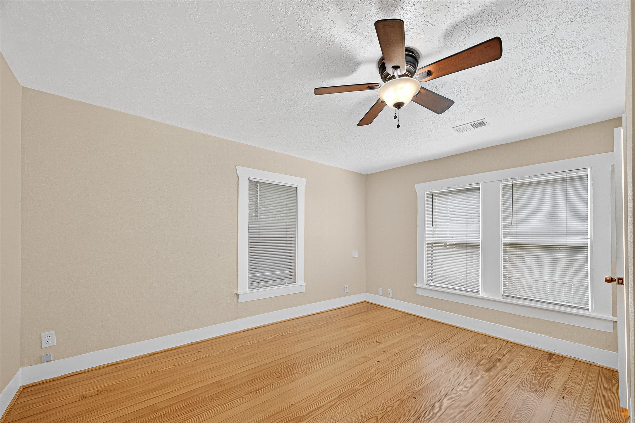 5122 Larkin Street Houston, TX 77007 - Photo 14 of 28 This front bedroom is accessed from the living room. The double windows look out to the fenced front yard.
