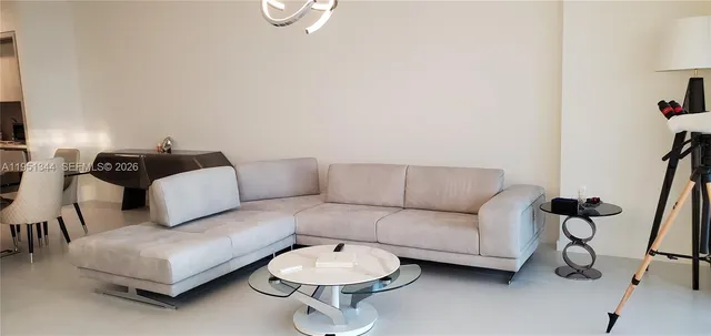 a living room with furniture a ceiling fan and a window