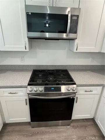 a stove top oven sitting inside of a kitchen