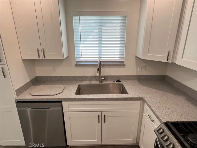 a kitchen with appliances cabinets and a sink