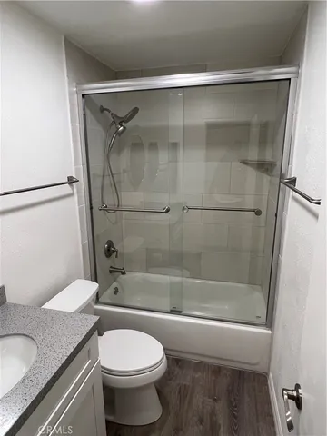 a bathroom with a granite countertop toilet sink and shower