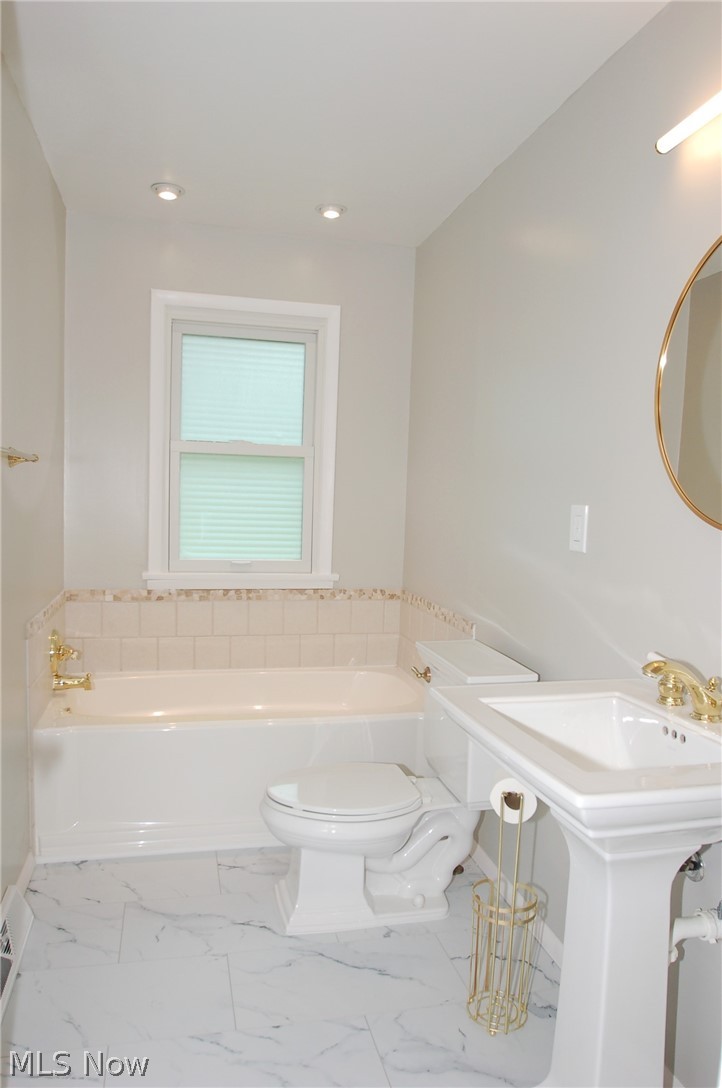 1299 State Road Vermilion, OH 44089 - Photo 11 of 36 Bathroom featuring tile patterned flooring, toilet, and a tub