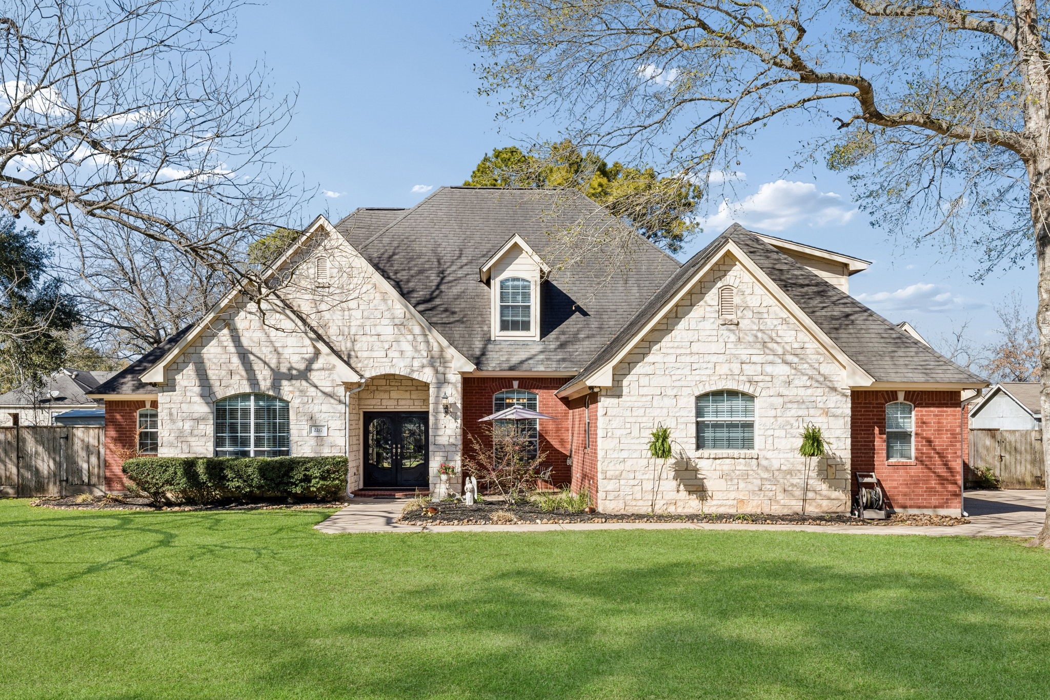Welcome to 2217 Bernie Ave, located in the community of Louis Polka. This home features distinctive architectural details, established landscaping, and sits on a nearly half-acre lot.