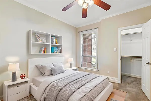 a bedroom with a bed and a book shelf