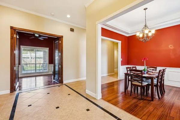 a view of a dining room with furniture wooden floor and chandelier