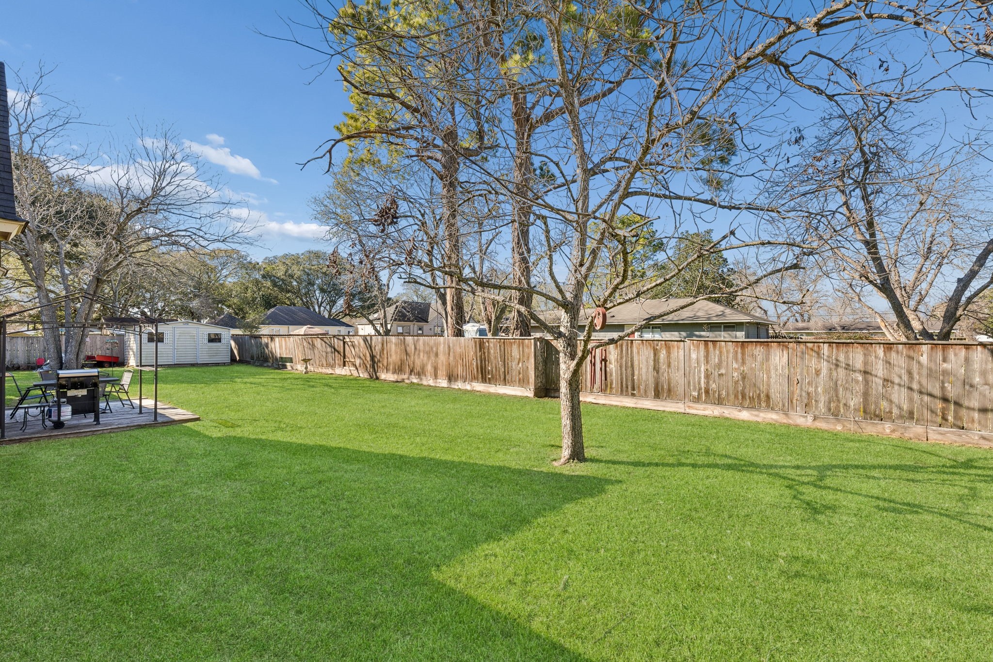 2217 Bernie Avenue Rosenberg, TX 77471 - Photo 21 of 25 Step out to the fully fenced back yard featuring a storage shed and a large patio perfect for outdoor gatherings and play.