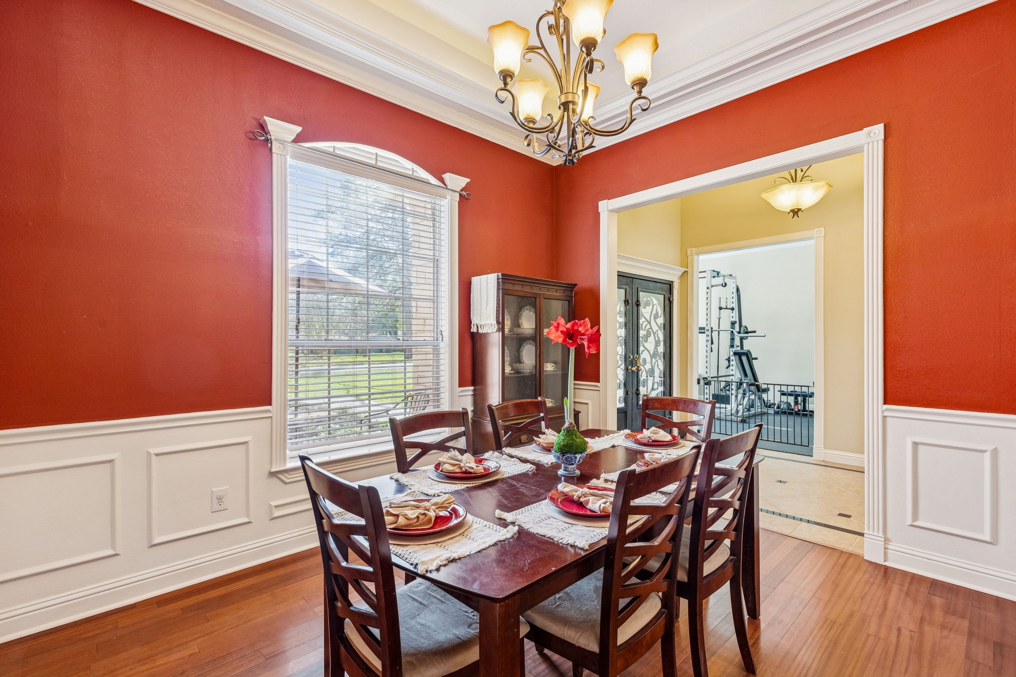 2217 Bernie Avenue Rosenberg, TX 77471 - Photo 3 of 25 Host elegant dinner parties in the formal dining room, featuring rich wood flooring, refined wainscoting, and a tray ceiling.