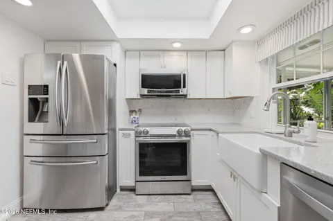 a kitchen with stainless steel appliances granite countertop a sink and a stove