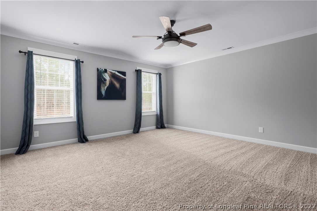 15581 Raccoon Run Road Wagram, NC 28396 - Photo 20 of 30 a view of a livingroom with a ceiling fan and window