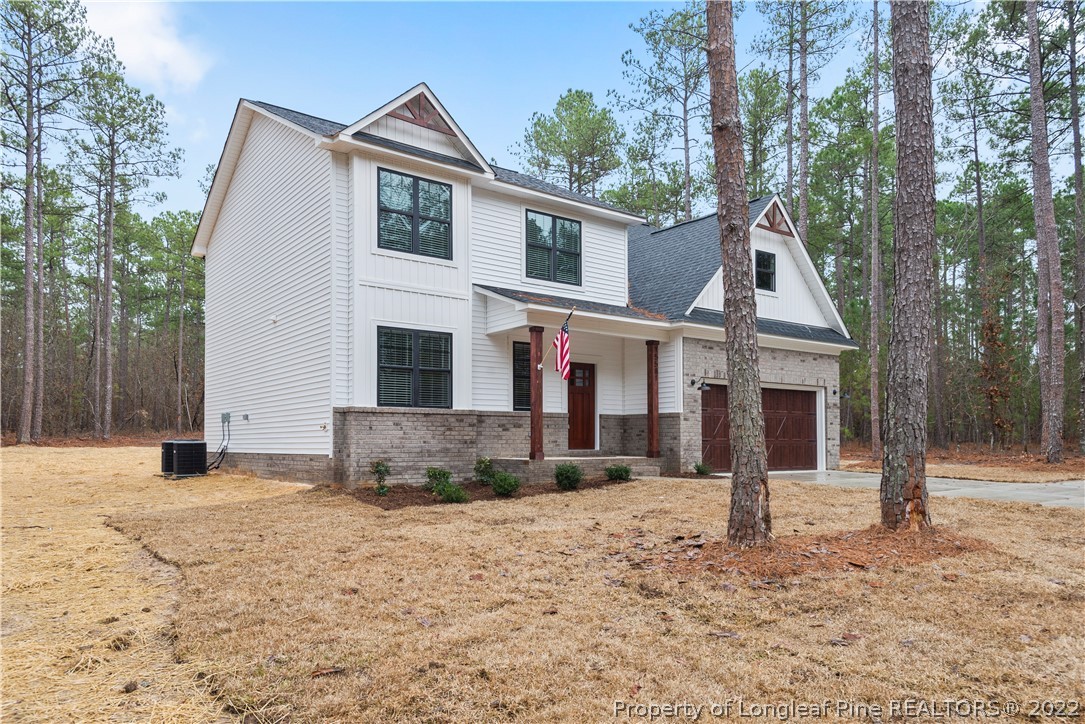 15581 Raccoon Run Road Wagram, NC 28396 - Photo 4 of 30 a front view of a house with a yard covered in snow