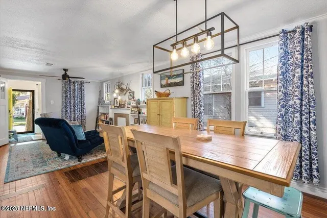 a dining room with furniture and wooden floor