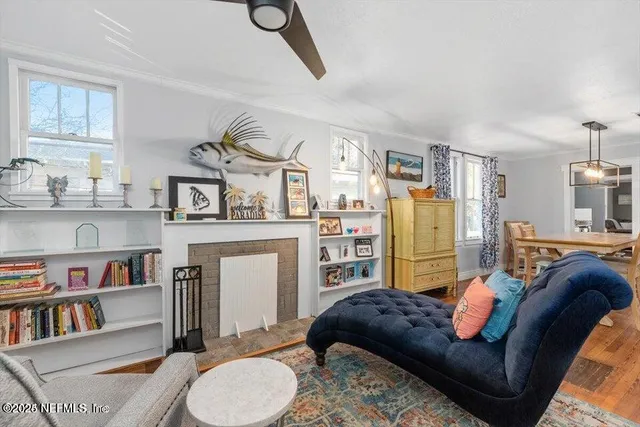 a living room with furniture and a book shelf